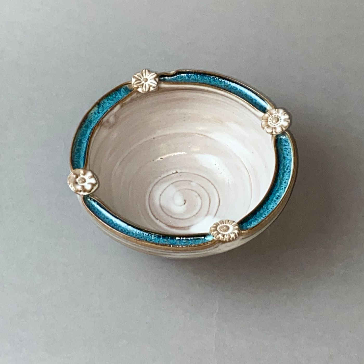 An elegant ceramic bowl with floral detailing and blue accents, suited to serving or to display.