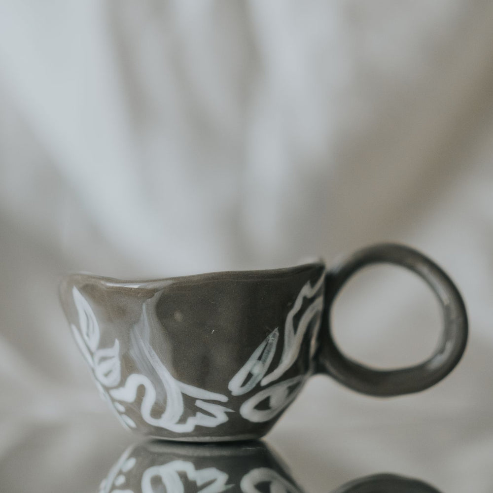 An artistic ceramic cup covered in ornate decoration, made in the traditional style of Eskisehir in Turkiye.